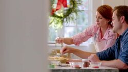 Man and woman talk and laugh while sprinkling sugar on lattice-top pie (dolly-shot) Stock Footage