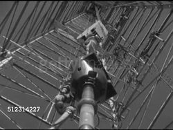 1952: OIL INDUSTRY: DRILLING: TU LS INSIDE Derrick rig center, drill line & blocks above w/ drill pipe turning.   Note: Slight movement.     Petroleum production, Global Warming, pollution, ecosystem, non-sustainable resources. Instructional Video