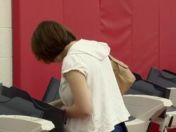 MS, ZO, Three women voting standing at electronic voting machines, Toledo, Ohio, USA Stock Footage