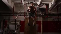 Man exercising on gymnastic rings Stock Footage