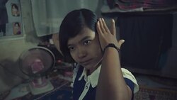 M/S Burmese teenage girl brushing her hair in her home Stock Footage