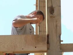 MS Carpenter marking beam during framing of an energy efficient post / Grass Lake, Michigan, USA       Stock Footage