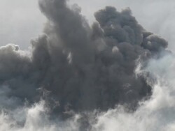 Zoom out of eruption of ash at Merapi volcano; Central Java, Indonesia. 29 October 2010 Stock Footage