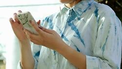 Attractive woman listening to music in the park Stock Footage