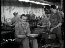 1943: WWII INDUSTRY:  Defense factory workers joking around, All aboard JAHCO Special, next stop Berlin, male hands making steam in pipe whistle, male workers creating sounds like train moving using shop tools. Other men working on machines. Instructional Video
