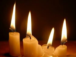 T/L four white, wax candles burning down to nothing Stock Footage