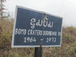 MS sign "Bomb Craters During War" / Phonsavan, Laos Stock Footage
