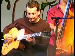 Gypsy Jazz guitarist Ritary Gaguenetti playing rhythm and lead, France Stock Footage
