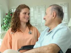 Nurse with Wheelchair Bound Male in Home Stock Footage