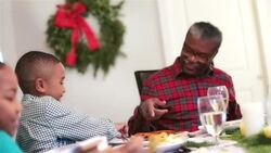 Grandpa points, tells grandson to eat his vegetables Stock Footage