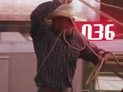 A cowboy with a lariat busts out the chute and attempts to rope a steer - shot in slow motion. Stock Footage