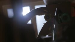 Hands tie price tag around vintage skateboard on sale in shop Stock Footage