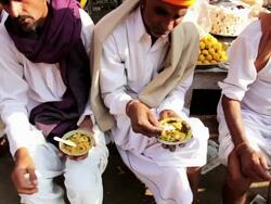CU ZO Shot of locals buying prepared food at local market food stall / Pushkar, Rajasthan, India  Stock Footage