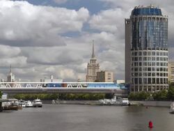 WS T/L View of river with small ships and modern bridge with high buildings of Stalin's era / Moscow, Russia Stock Footage