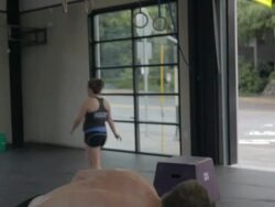 Medium close-up. Casey performs series of dumbell snatches. Stock Footage