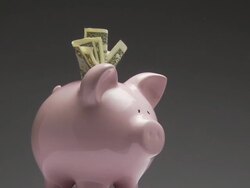 MS, Studio shot of pink piggy bank with one dollar bills rotating Stock Footage