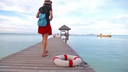 HD Dolly:Woman walking and take photo on wooden bridge. Stock Footage