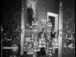 1936: U.S. WHITE HOUSE: RED ROOM: MS Portrait of Ex President Theodore 'Teddy' Roosevelt. MS Mirror w/ reflection of Red Room. MS Servant setting table, portrait of Ex Pres. John Tyler BG. VS CU Ship model, pouring into elaborate cup. Washington D.C. Instructional Video