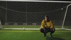A goaltender crouches and buries his head in his hands after missing a goal. Stock Footage