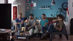 Guys sitting on couch watching horror movie Stock Footage