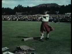 The Braemar Gathering near Balmoral. The Tug of War. Throwing the Hammer. Tossing the Caber. Highland Games. British tradition, 1958 Stock Footage