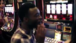 Friends freak out and cheers drinks as young woman wins at slots in Vegas casino Stock Footage