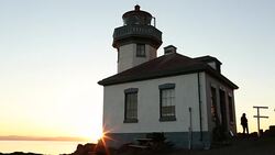 The lighthouse at Lime Kiln State Park on San Juan Island on a sunny day. Stock Footage