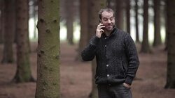 Happy man in a forest talking Stock Footage