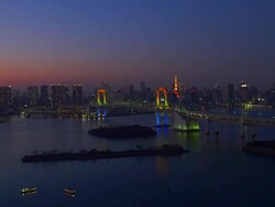 Tokyo tower and rainbow bridge light up time lapse at dusk Stock Footage