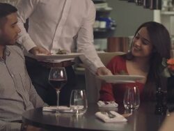 MS TU Young couple having food and drinking wine in restaurant Stock Footage