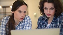 Two beautiful girls with laptop Stock Footage