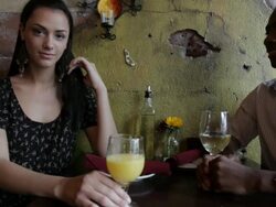 MS Young woman sitting  with  guy drinking beverages  in restaurant  / Minneapolis, Minnesota, United States Stock Footage
