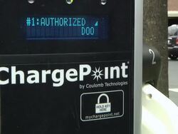 CU TD After swiping card to authorize use, connector being removed from charging port to be connected to charging socket of electric car / Rochester, Michigan, United States Stock Footage