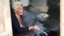 Pitiable Senior asian woman Sitting a Cooking Food Stock Footage