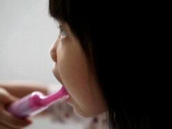 Asian female child enjoying her tooth brushing routine Stock Footage