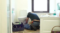 HD DOLLY: Plumber / Handyman fixing the Toilet in Bathroom Stock Footage