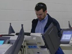 MS Shot of male voter casts ballot at copmuter terminal during voting in presidential election / Sylvania, Ohio, United States  Stock Footage