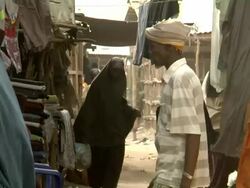 Muslim girls walk through village Stock Footage