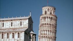 Tourists walk on the upper terraces of the Leaning Tower of Pisa in Italy. Stock Footage