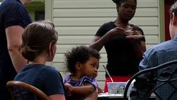 MS PAN Teenage girl holding infant sister in lap during birthday celebration Stock Footage