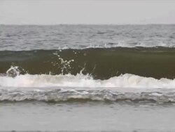Waves hitting the beach at sunrise, early morning Stock Footage