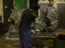 Artists carve a horse-dragon ice sculpture. Stock Footage