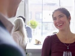 MS smiling couple in discussion in restaurant bar drinking wine Stock Footage