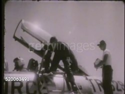 1963: UNITED STATES AIR FORCE ACADEMY: VS Male cadet/pilot exiting cockpit of jet aircraft, cadets on field doing push-ups (physical training, PT). Colorado, CO, Rampart Range, doolies, basic training, conditioning Instructional Video