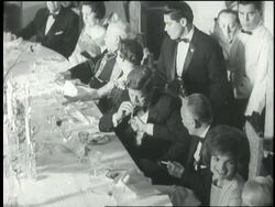 Colombian President Alberto Lleras Camargo lights a cigar for President John F. Kennedy at a formal banquet at San Carlos Palace. News Clip