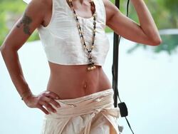 MS TU Italian model with tattoo on arm under lighting umbrella with pool / Montezuma, Punteranes, Costa Rica Stock Footage