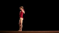LD Female gymnast performing a routine on balance beam Stock Footage
