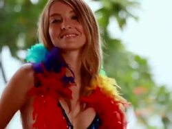 MS TD TU Female model on motorcycle modelling bathing suit and moving to  rythmn while putting on feather boa / Montezuma, Punteranes, Costa Rica Stock Footage