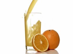 MS SLO MO Orange juice pouring into glass against white background / Vieux Pont, Normandy, France Stock Footage