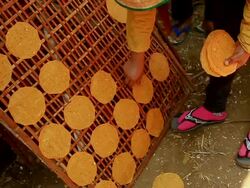 MS SLO MO Shot of woman removing cassava crackers from bamboo panel / Luang Prabang, Laos Stock Footage